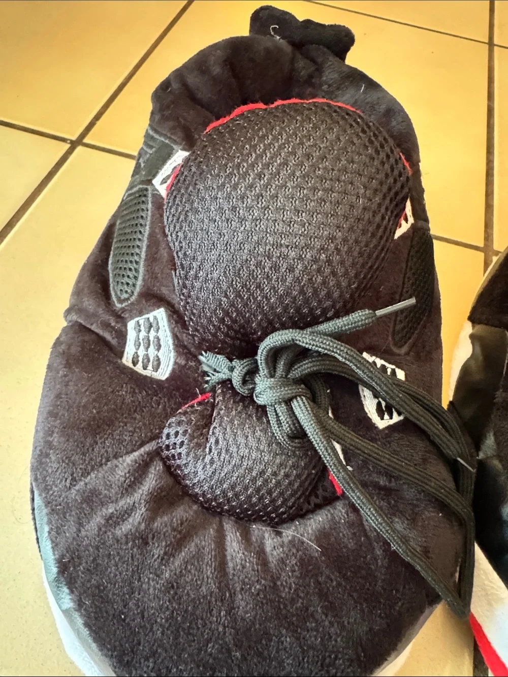 Air Jordan Kids Black and Red fuzzy slippers.